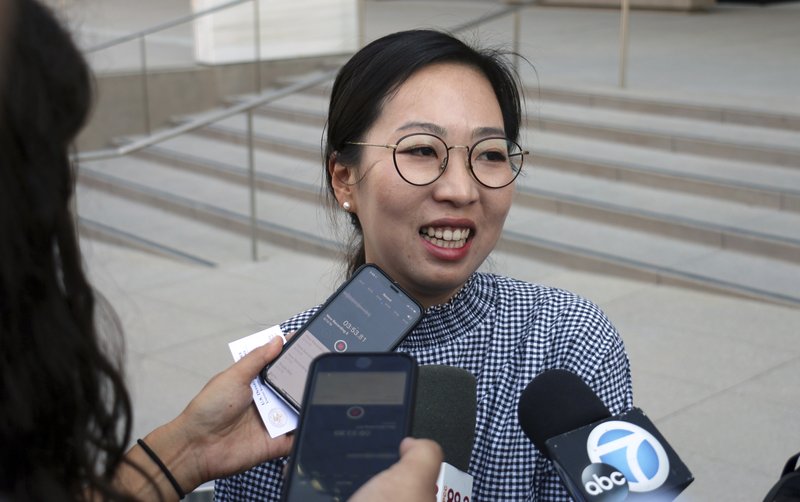 Yea Ji Sea, a former U.S. Army specialist who was born in South Korea, talks with reporters after a federal court hearing in Los Angeles Tuesday, Aug. 14, 2018. 