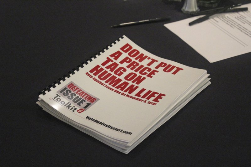 In this July 26, 2018 photo, an information booklet about a &quot;tort reform&quot; measure appearing on Arkansas' ballot sits on a table at a breakfast meeting of pastors in Little Rock, Arkansas. The Family Council Action Committee, a conservative Christian group, is rallying churches against the ballot measure to impose new limits on lawsuit damages. (AP Photo/Andrew Demillo)