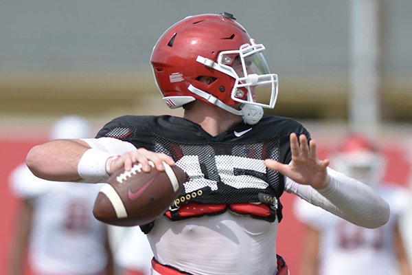 Arkansas quarterback Cole Kelley passes Tuesday, Aug. 7, 2018, during practice at the university practice fields in Fayetteville. 