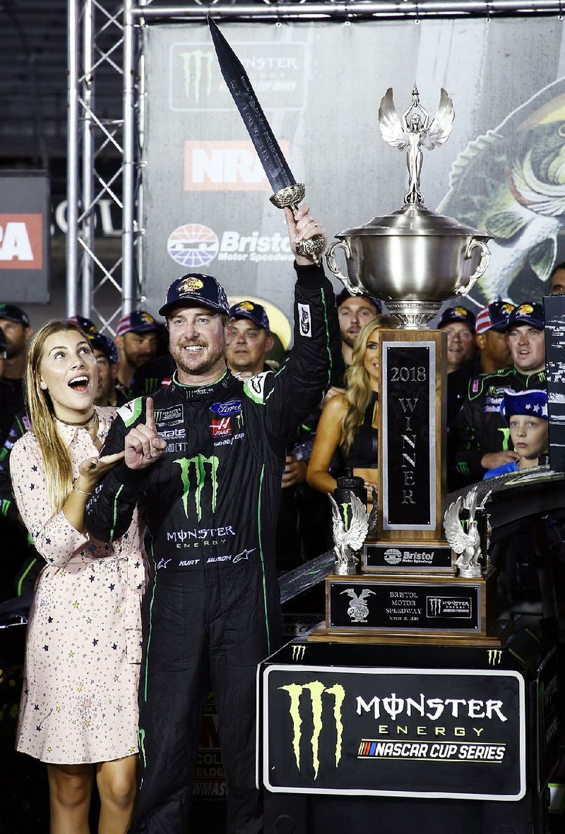 Kurt Busch celebrates with his wife, Ashley Van Metre, after winning the NASCAR Cup Series auto race Saturday, Aug. 18, 2018, in Bristol, Tenn. 