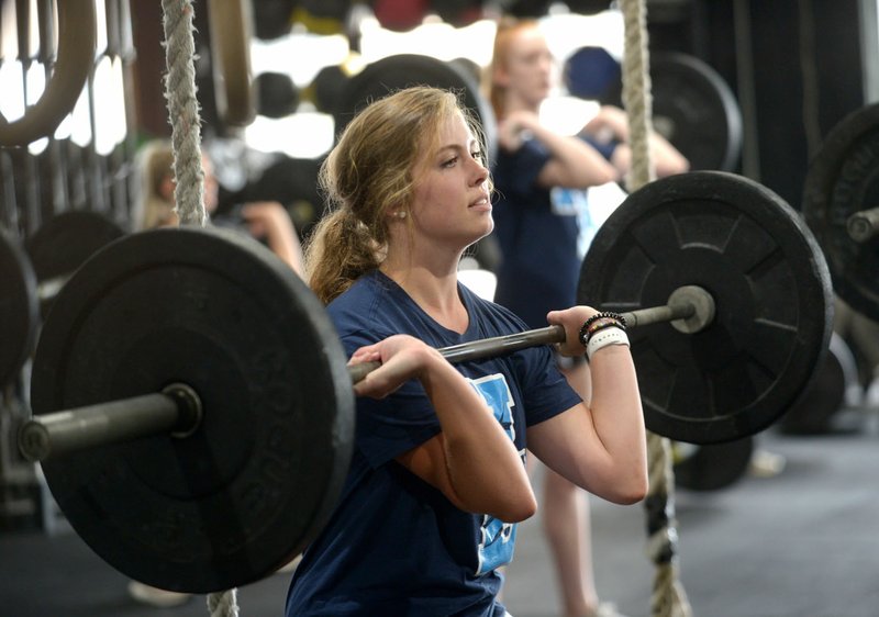 NWA Democrat-Gazette/ANDY SHUPE Molly Kingston, 17, a senior at Har-Ber High School, demonstrates a workout the team has been using Wednesday, Aug. 15, 2018, at CrossFit 540 in Springdale. The Springdale Har-Ber volleyball team spent the offseason doing CrossFit workouts to get ready for the season.