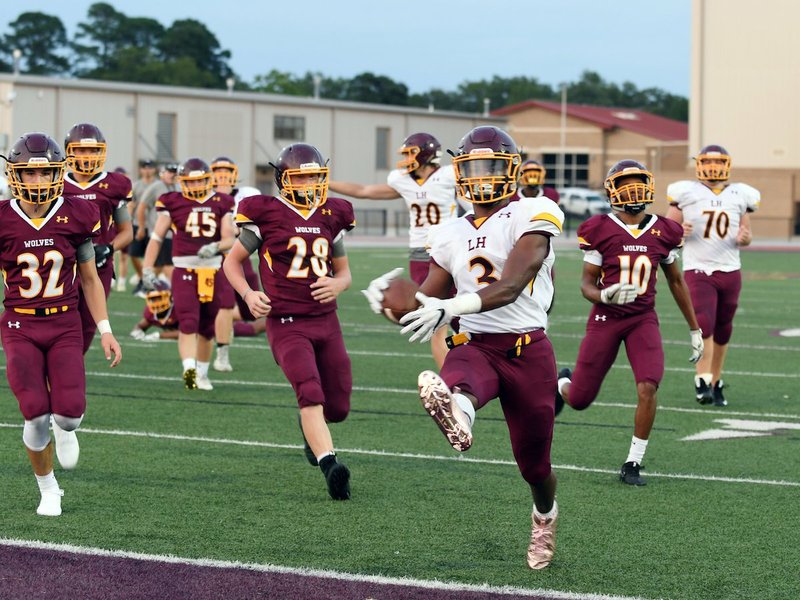 The Sentinel-Record/Grace Brown - Lake Hamilton's Malik Brewer (3) makes his way into the in-zone for a touch down as Lake Hamilton's Pearson Hafer (32), Izaiah Clenney (28), and Tre Darrough (10) attempt to catch him during the maroon and gold game at Lake Hamilton on Friday, August 17, 2018.