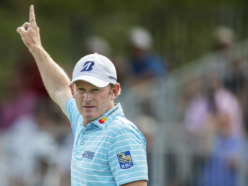 Brandt Snedeker raises his arm after sinking an eagle putt on the 15th hole during the second round of the Wyndham Championship golf tournament at Sedgefield Country Club in Greensboro, N.C., Friday, Aug. 17, 2018. (Khadejeh Nikouyeh/News &amp; Record via AP)