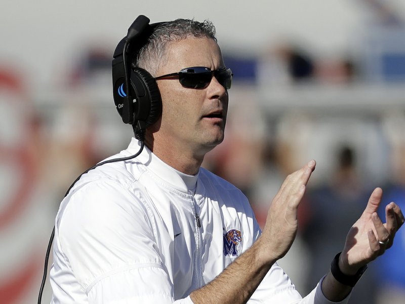 FILE -- In this Nov. 25, 2017 file photo, Memphis head coach Mike Norvell cheers his players after a touchdown against East Carolina an NCAA college football game in Memphis, Tenn. The Tigers believe they have enough firepower to contend for the American Athletic Conference title even without departed quarterback Riley Ferguson and receiver Anthony Miller. (AP Photo/Mark Humphrey, File)