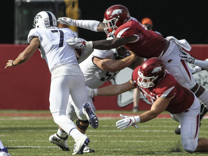 Arkansas Democrat-Gazette/MITCHELL PE MASILUN --9/9/2017--
Arkansas' defensive linemen #41 Austin Capps (bottom) and Linebacker #8 De&#x201a;&#xc4;&#xf4;Jon Harris track down TCU quarterback #7 Kenny Hill during their game at Donald W. Reynolds Razorback Stadium in Fayetteville Saturday, September 9, 2017.