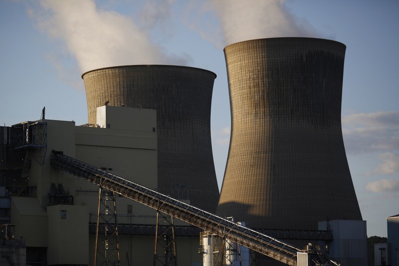 Steam rises from cooling towers at the American Electric Power Co. coal-fired power plant in Winfield, W.Va., on July 18. MUST CREDIT: Bloomberg photo by Luke Sharrett