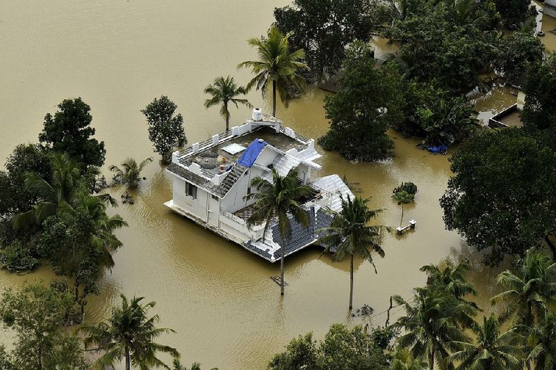 A house is partially submerged Sunday in floodwaters in Chengannur, Kerala, in southern In- dia. A disaster management official said this year’s monsoon season has killed more than 350 people and displaced 800,000 in Kerala state alone.