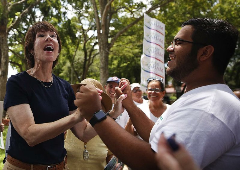 Democratic gubernatorial candidate Gwen Graham thanks a campaign volunteer, Juan Sabater, 20, of Miami, as she speaks to voters in a “Get Out The Vote” tour in Miami Lakes, Fla., on Saturday.
