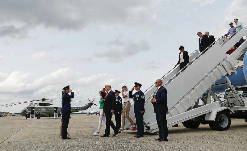 President Donald Trump arrives Sunday at Andrews Air Force Base, Md., with first lady Melania Trump and son Barron Trump. 