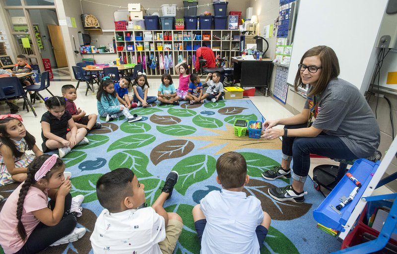 NWA Democrat-Gazette/BEN GOFF &#8226; @NWABENGOFF Kayla Wildenborg, first-grade teacher, gets to know her class Wednesday on the first day of the school year at Russell D. Jones Elementary in Rogers.