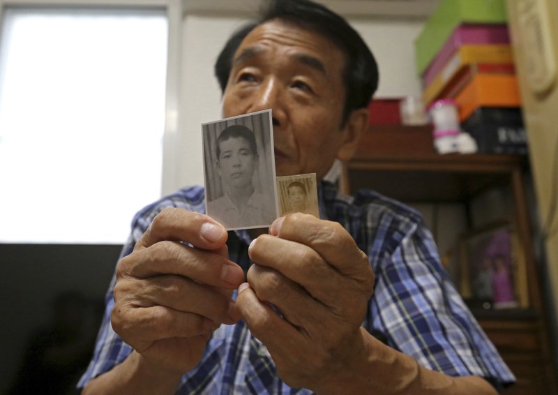 In this Aug. 17, 2018, photo, Lee Soo-nam, 76, shows photos of his brother Ri Jong Song in North Korea during an interview at his home in Seoul, South Korea. Lee is among about 200 war-separated South Koreans and their family members who are crossing into North Korea for heart-wrenching meetings with relatives they haven&#x2019;t seen for decades. The week-long event beginning Monday, Aug. 20, 2018, at North Korea&#x2019;s Diamond Mountain resort come as the rival Koreas boost reconciliation efforts amid a diplomatic push to resolve the North Korean nuclear crisis. (AP Photo/Ahn Young-joon)