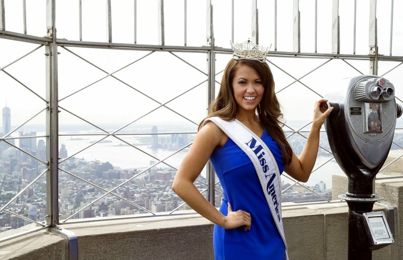 FILE - In this Sept. 12, 2017, file photo, newly-crowned Miss America 2018 Cara Mund poses for photographers on the 86th Floor Observation Deck of the Empire State Building, in New York. Miss America chairwoman Gretchen Carlson has struck back against the reigning Miss America, saying Mund’s allegations that Carlson and others have bullied and silenced her has led to the loss of $75,000 in scholarship money for this year’s contestants.(AP Photo/Mary Altaffer, File)