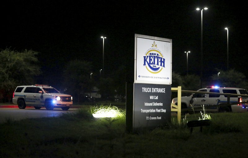 Authorities investigate the scene after a deadly shooting at Ben E. Keith distribution center Monday, Aug. 20, 2018, in Missouri City, Texas. Missouri City Police Chief Mike Berezin says the shooting happened during the overnight shift, when fewer workers are on duty. (Yi-Chin Lee/Houston Chronicle via AP)

