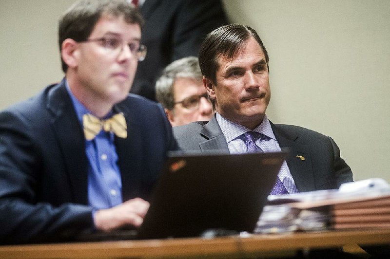 Nick Lyon (right), director of the Michigan Department of Health and Human Services, listens Monday at Genesee District Court in Flint, Mich., as he is ordered to stand trial for involuntary man- slaughter in two deaths linked to tainted water in Flint. 