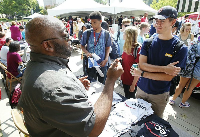 NWA Democrat-Gazette/DAVID GOTTSCHALK Jonathan Elliot (left), with University Recreation, describes Monday, August 20, 2018, the recreational opportunities, facilities and programs available to Connor Pocta, a senior, at the University of Arkansas during Hillfest at the Arkansas Union Mall on campus in Fayetteville. Hillfest is an information fair for students to meet campus departments and Registered Student Organizations. The fair included food, music, giveaways and information booths.