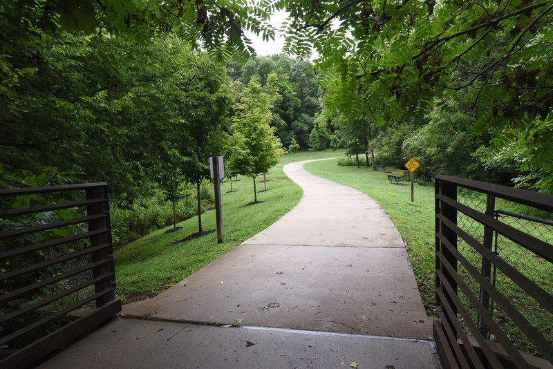 NWA Democrat-Gazette/FLIP PUTTHOFF Bike riders should exercise caution if they run off the concrete surface of the Razorback Greenway. Turning back on the trail too quickly can cause a spill.