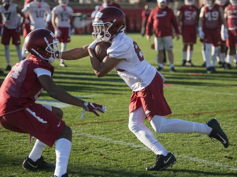 NWA Democrat-Gazette/Ben Goff SECOND YEAR: Arkansas sophomore receiver Jarrod Barnes, right, runs through a drill with redshirt freshman defensive back Jarques McClellion on March 1 during a spring practice at the Fred W. Smith Football Center in Fayetteville.