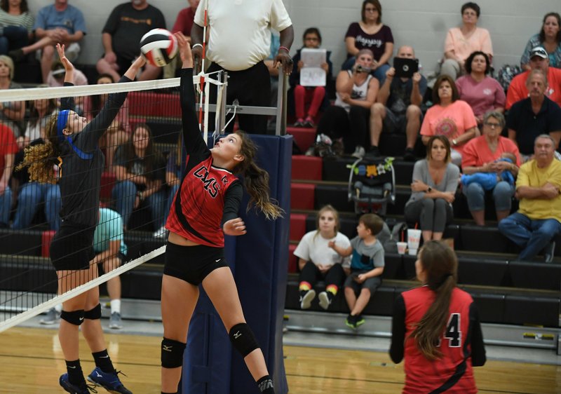 The Sentinel-Record/Grace Brown OVER THE TOP: Cutter Morning Star's Kendyll Knott-Debord (12) pushes the ball over the net Monday as Sheridan's Taylor Uptagrafft (1) tries to block during a volleyball game at Cutter Morning Star's multi-use facility. Sheridan took a 3-0 win in the match.