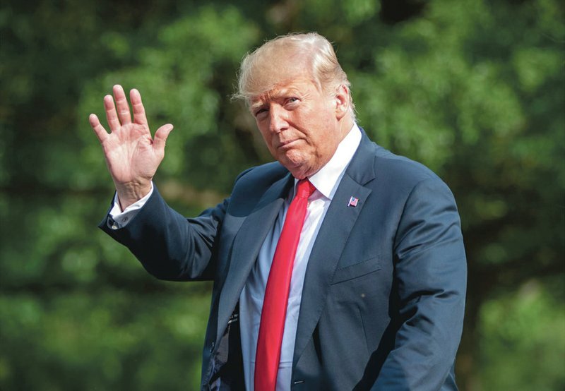 The Associated Press PRESIDENT WAVES: President Donald Trump waves as he arrives at the White House in Washington, Sunday after spending the weekend at his golf club in Bedminster, N.J.