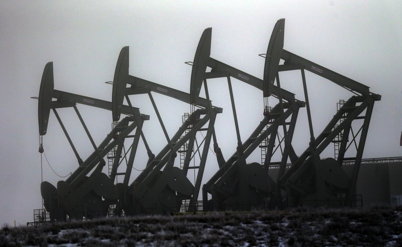 In this December 2014 file photo, oil pump jacks work in unison in Williston, N.D. Conserving oil is no longer an economic imperative for the U.S., the Trump administration declares in a major new policy statement that threatens to undermine decades of government campaigns for gas-thrifty cars and other conservation programs. (AP Photo/Eric Gay, File)
