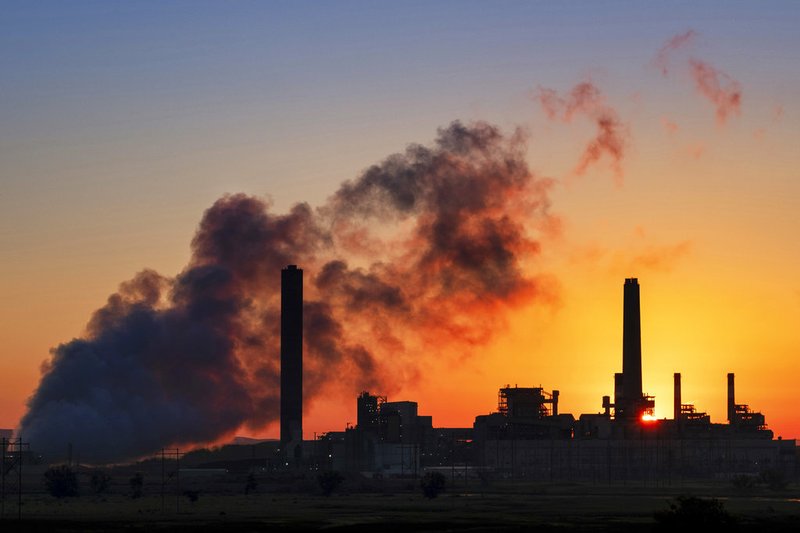 In this July 27, 2018 photo, the Dave Johnson coal-fired power plant is silhouetted against the morning sun in Glenrock, Wyo. (AP Photo/J. David Ake)

