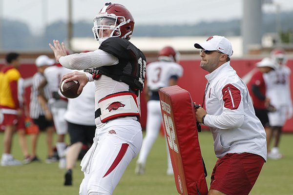 Arkansas offensive coordinator Joe Craddock, right, works with quarterback Cole Kelley during practice Wednesday, Aug. 8, 2018, in Fayetteville.	