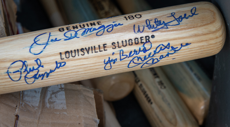 Forged signatures were chemically removed from more than 500 bats seized in a sports memorabilia forgery case and donated to youth leagues in Little Rock and Chicago.