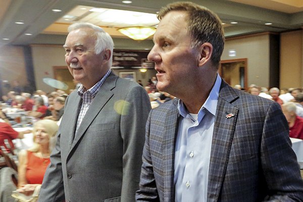 Arkansas coach Chad Morris, left, walks with Gary Underwood prior to the Little Rock Touchdown Club on Monday, Aug. 20, 2018, at Embassy Suites Hotel in Little Rock.	