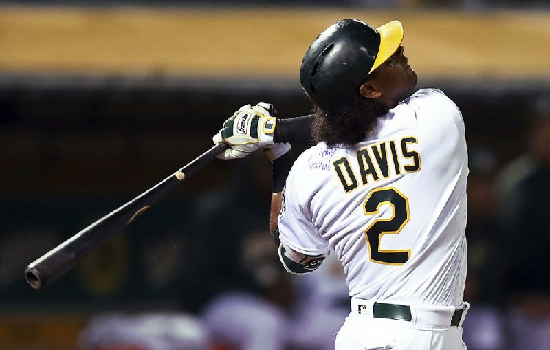 The Oakland A’s jersey of Khris Davis is signed on the upper left shoulder by Anthony Slocumb, a child from the Make-A-Wish Foundation. 