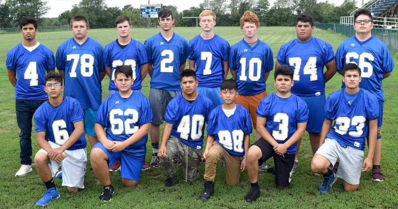 Westside Eagle Observer/MIKE ECKELS The 2018 Decatur Bulldog eight-man football team takes time for a quick photograph before hitting the practice field behind Bulldog Stadium Aug. 13.