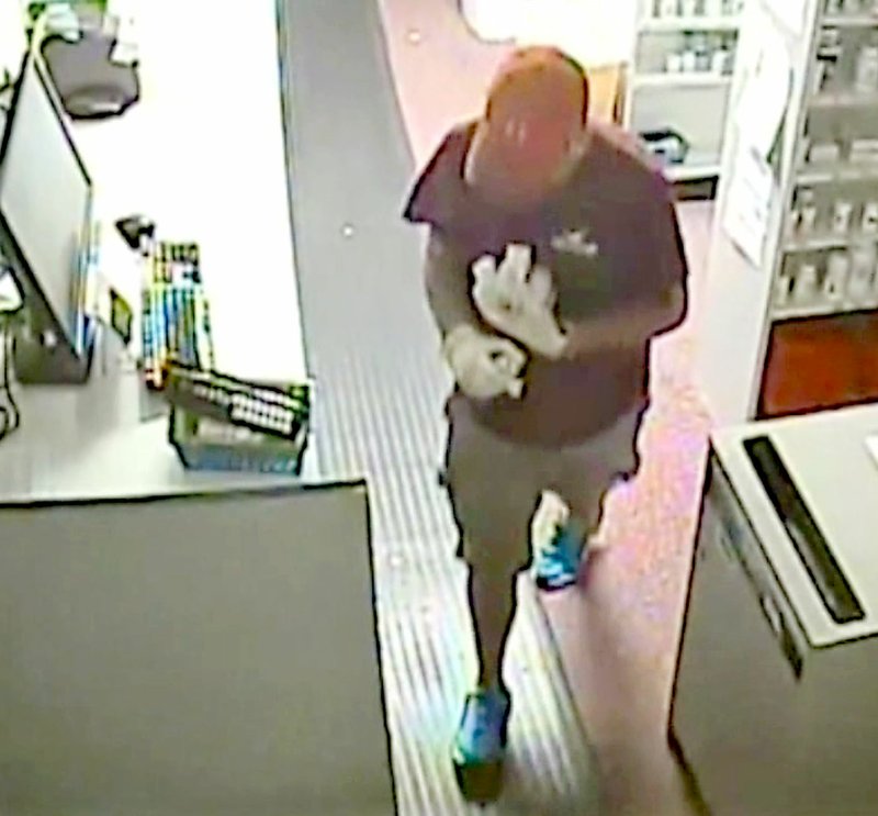 SUBMITTED Surveillance video reveals this man looking for drugs inside the drug store.