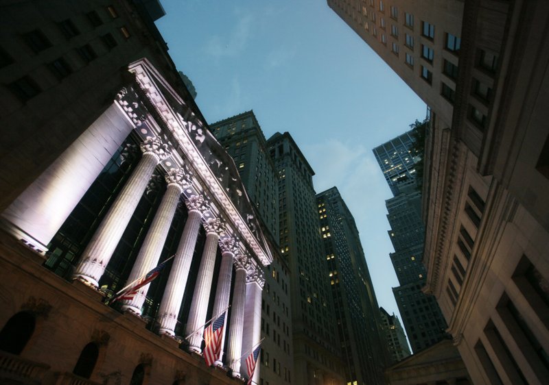 In this Oct. 8, 2014, file photo, American flags fly in front of the New York Stock Exchange. 