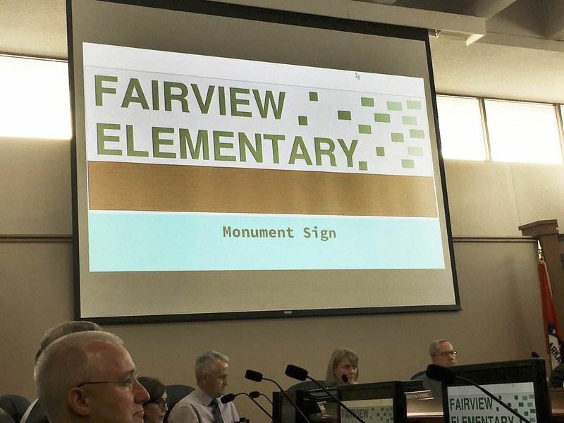 NWA Democrat-Gazette/DAVE PEROZEK The Rogers School Board heard a presentation Tuesday on the attendance rezoning process associated with next year's opening of Fairview Elementary School. The graphic on the screen shows how Fairview's monument sign outside the building will look.