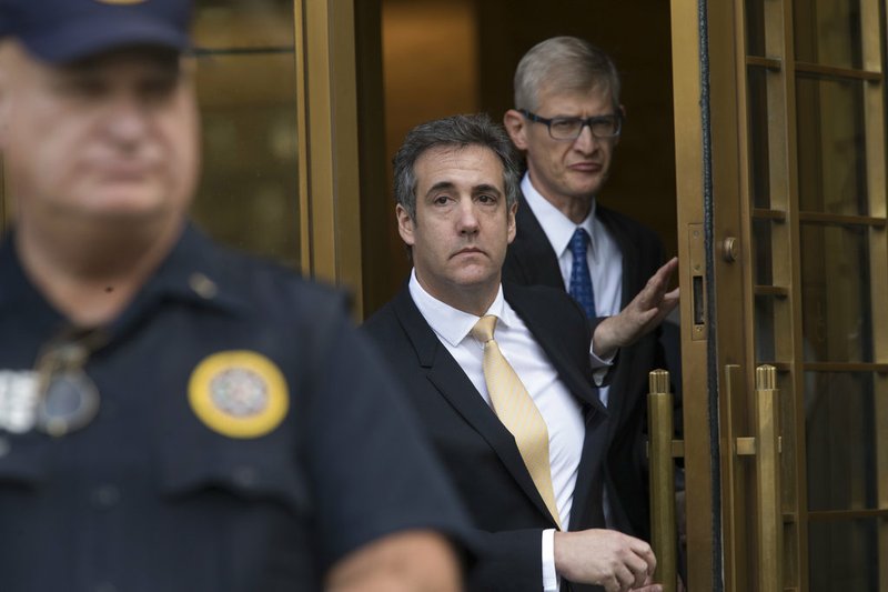 Michael Cohen, center, leaves Federal court, Tuesday, Aug. 21, 2018, in New York. Cohen, has pleaded guilty to charges including campaign finance fraud stemming from hush money payments to porn actress Stormy Daniels and ex-Playboy model Karen McDougal. (AP Photo/Mary Altaffer)

