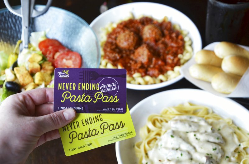 This undated photo provided by Olive Garden shows their new annual pasta pass, top, and their eight weeks of unlimited access pasta pass. The passes go on sale starting at 2 p.m. EDT Thursday, Aug. 23, 2018, at www.PastaPass.com. (Olive Garden via AP)

