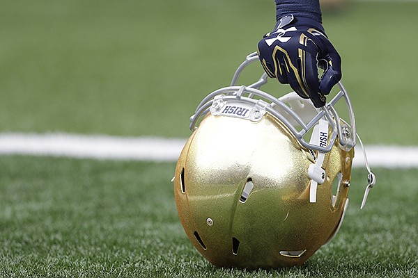 A Notre Dame player holds his helmet after running onto to field before an NCAA college football game Saturday, Oct. 29, 2016, in South Bend, Ind. The Fighting Irish are scheduled to play Arkansas in 2020 and 2025, the first meeting between the programs, part of a scheduling strategy implemented by Notre Dame's longtime AD Jack Swarbrick. (AP Photo/Darron Cummings)	