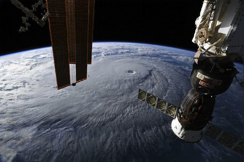 Astronauts aboard the International Space Station get a big-picture view of Hurricane Lane on Wednesday as it bears down on Hawaii. The storm weakened from a Category 5 hurricane to Category 4, but was still expected to be a major hurricane. As people crowded into stores for supplies, the Navy moved its ships and submarines to calmer waters.   
