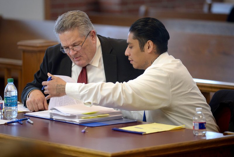 Giovanni Vasquez-Sanchez (right) speaks with Fayetteville attorney Erwin Davis during Vasquez-Sanchez's trial at the Washington County Courthouse in Fayetteville.