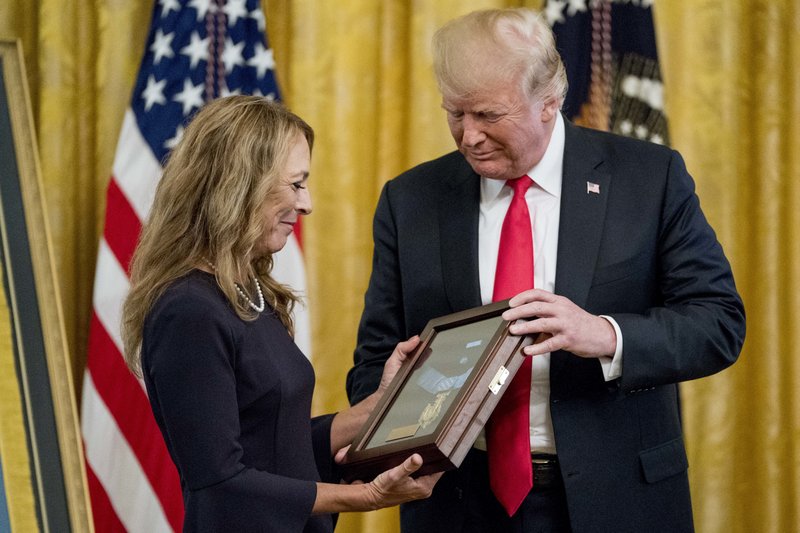 Valerie Nessel accepts the Medal of Honor from President Donald Trump for her husband Air Force Tech. Sgt. John A. Chapman, posthumously for conspicuous gallantry during a ceremony in the East Room of the White House in Washington, Wednesday, Aug. 22, 2018. 