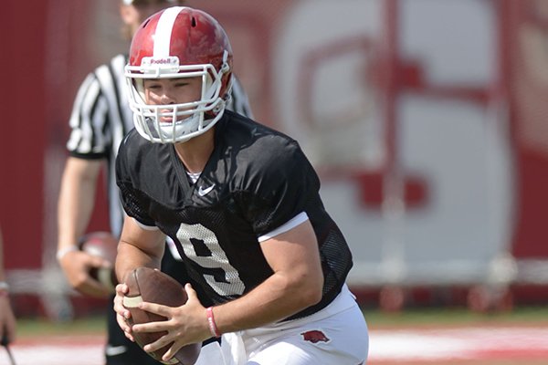 Arkansas quarterback John Stephen Jones rolls out to pass Thursday, Aug. 9, 2018, during practice at the university's practice facility in Fayetteville. 