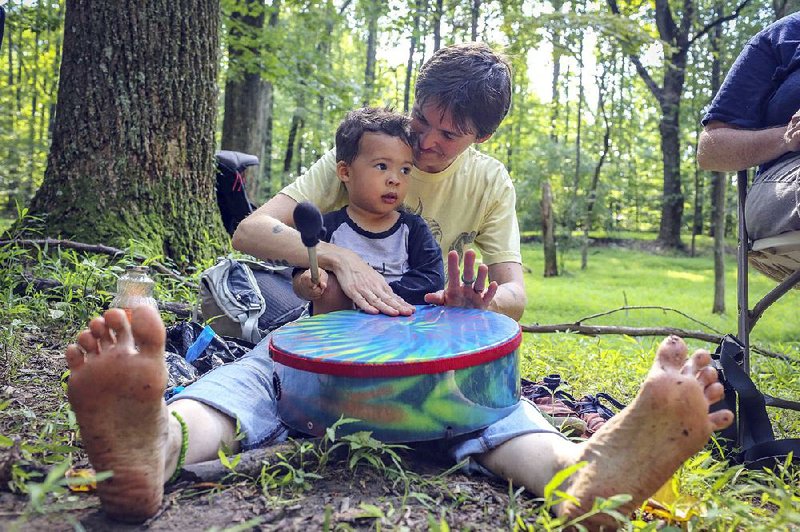 Kristina Byrne drums with her son Adisa Jones, 2, at the Center for Spirituality in Nature’s monthly outdoor service, dubbed Church of the Wild. 
