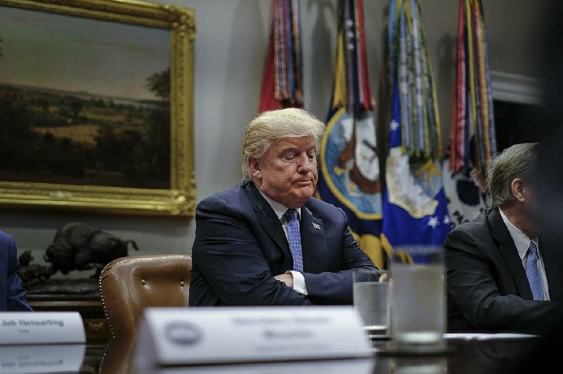 President Donald Trump attends a round-table discussion on foreign investment legislation with lawmakers Thursday at the White House. 
