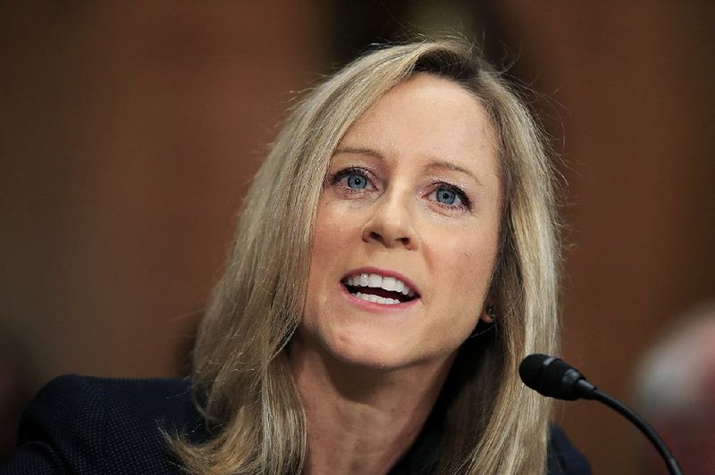 In this July 19, 2018, file photo, Kathleen Kraninger, President Donald Trump's nominee to be the director of the Bureau of Consumer Financial Protection, testifies before a Senate Banking Committee hearing on her confirmation on Capitol Hill in Washington. The Senate Banking Committee has approved Kraninger to run the Consumer Financial Protection Bureau with a 13-12 party-line vote. 