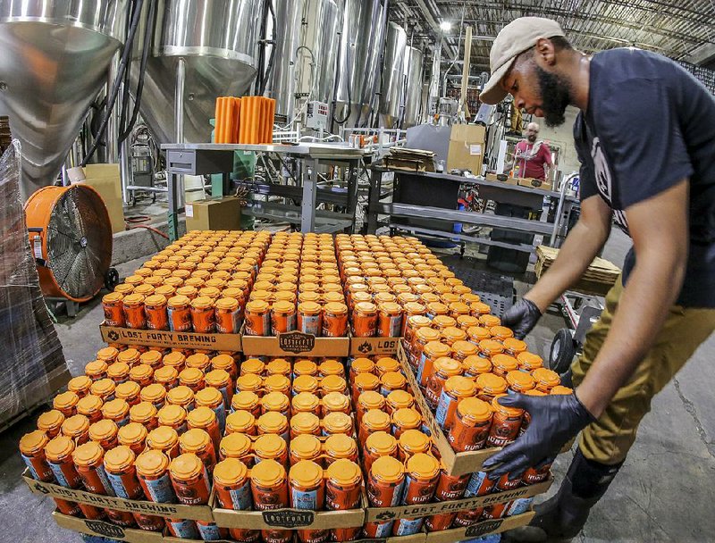 Lost Forty employee L.D. Moore stacks cases at the brewery earlier this month. The Little Rock-based brewer produced the equivalent of 12,075 barrels of beer in 2017, nearly a third of the state’s total beer production. 