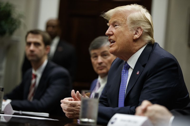 President Donald Trump listens during a roundtable on the &quot;Foreign Investment Risk Review Modernization Act&quot; in the Roosevelt Room of the White House, Thursday, Aug. 23, 2018, in Washington. From left, Sen. Tom Cotton, R-Ark., Rep. Jeb Hensarling, and Trump. (AP Photo/Evan Vucci)