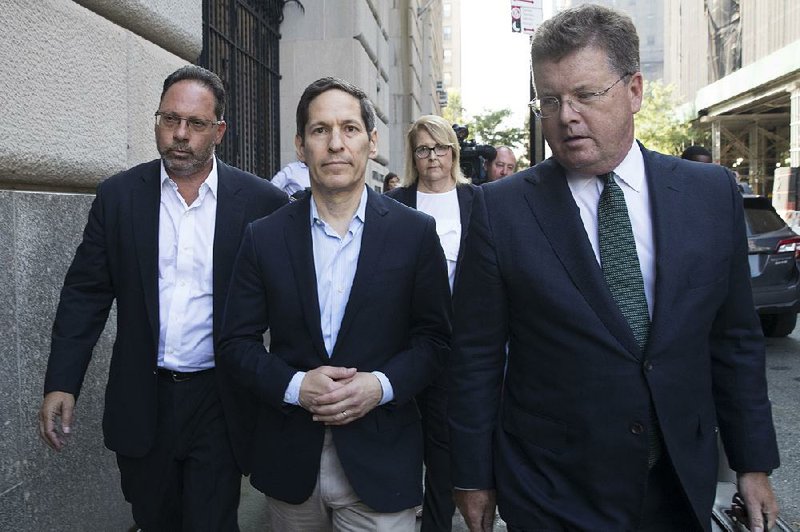 Thomas Frieden, (center) a former chief of the Centers for Disease Control and Prevention, leaves a Brooklyn, N.Y., court Friday after a hearing in a sex-abuse case. 