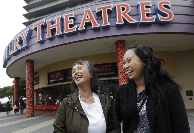 In this Thursday, Aug. 23, 2018 photo, Alice Sue, left, and her daughter Audrey Sue-Matsumoto laugh while interviewed after watching the movie Crazy Rich Asians in Daly City, Calif. It was Sue's second time watching the movie. When &quot;Crazy Rich Asians&quot; surpassed expectations and grabbed the top spot in its opening weekend, the film also pulled off another surprising feat. It put Asians of a certain age in theater seats. (AP Photo/Jeff Chiu)