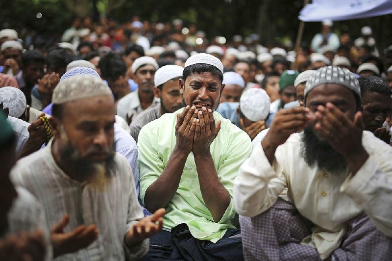 Rohingya gather in prayer Saturday at the Kutupalong refugee camp in Bangladesh, where they expressed their hopes of someday returning to their homes in Burma.