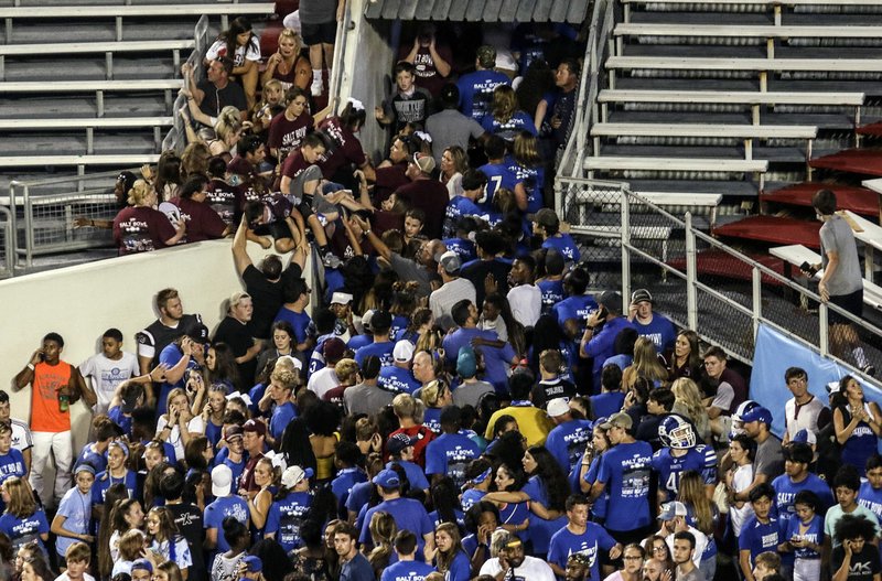 Arkansas Democrat-Gazette/MITCHELL PE MASILUN --7/25/2018-- People try to exit the stadium after an incident during the Salt Bowl at War Memorial Stadium in Little Rock Saturday, August 25, 2018.