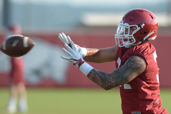 Arkansas linebacker Grant Morgan participates in a drill Friday, Aug. 3, 2018, during practice at the university practice field on campus in Fayetteville. 